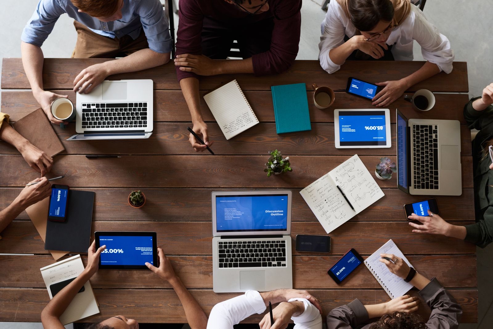 Business team collaborating with laptops using Microsoft 365 productivity tools
