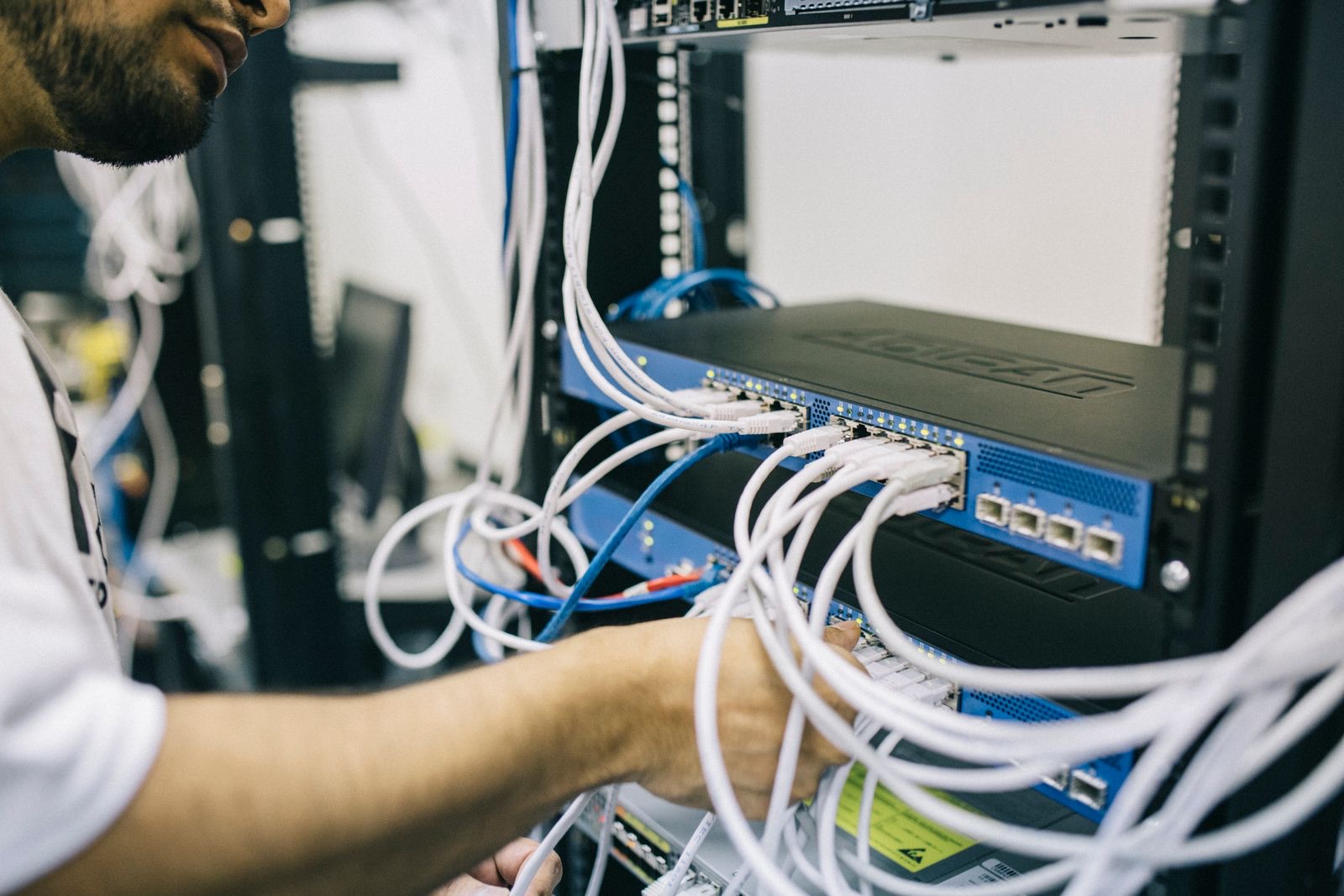 Technician installing Ethernet cabling in a commercial building