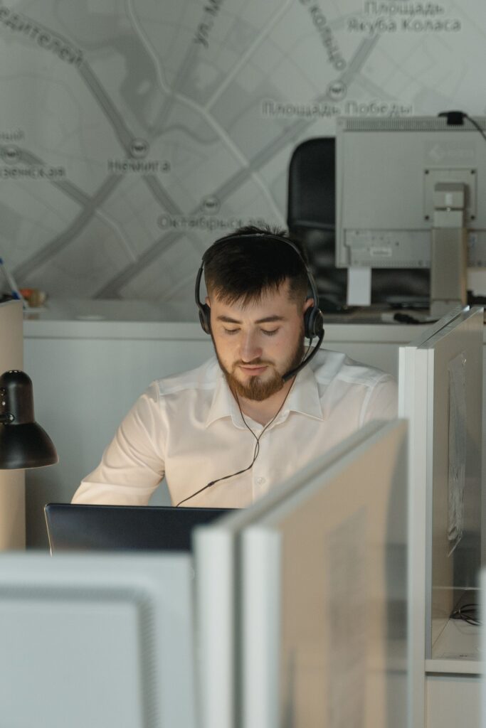 IT technician providing remote computer support from an office workstation